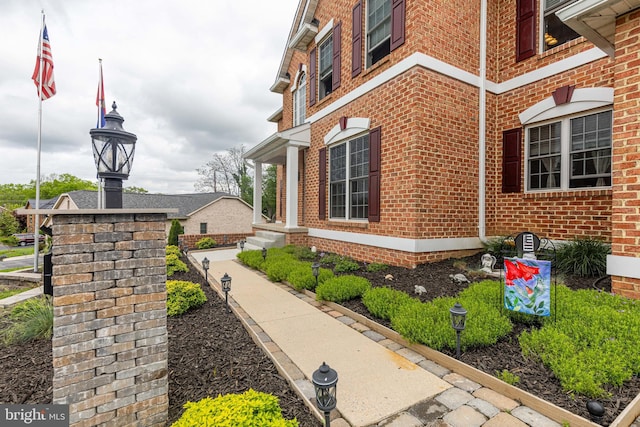 view of side of property featuring brick siding