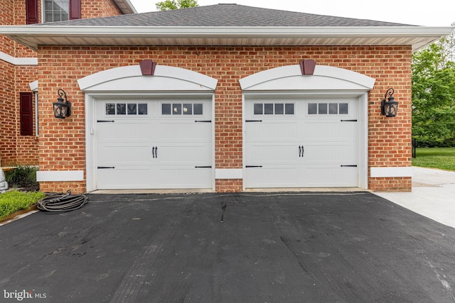 garage with asphalt driveway