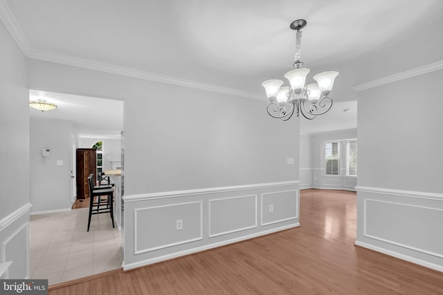 5620 Nutwell Sudley Rd, Deale, MD 20751 - unfurnished room with a chandelier, crown molding, light wood-type flooring, and wainscoting