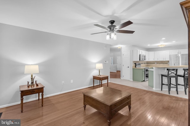 5620 Nutwell Sudley Rd, Deale, MD 20751 - living room with light wood-style flooring, recessed lighting, baseboards, and ceiling fan