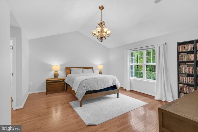5620 Nutwell Sudley Rd, Deale, MD 20751 - bedroom featuring wood finished floors, lofted ceiling, a chandelier, and baseboards