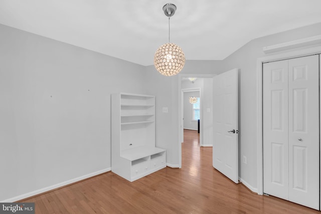 5620 Nutwell Sudley Rd, Deale, MD 20751 - unfurnished dining area featuring wood finished floors, a chandelier, and baseboards
