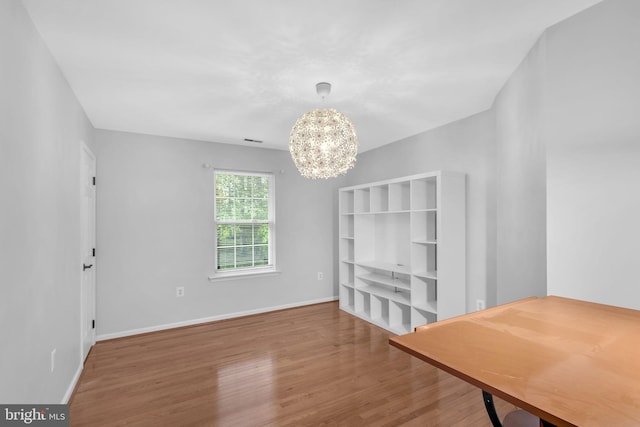 5620 Nutwell Sudley Rd, Deale, MD 20751 - unfurnished dining area with a chandelier, wood finished floors, and baseboards