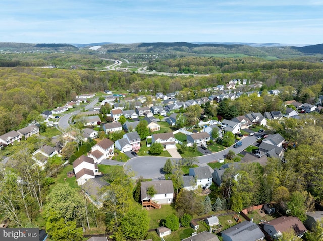 aerial view with a mountain view, a wooded view, and a residential view