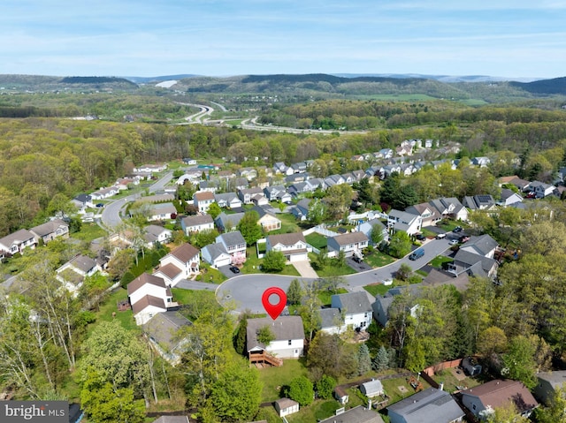 birds eye view of property with a forest view, a residential view, and a mountain view