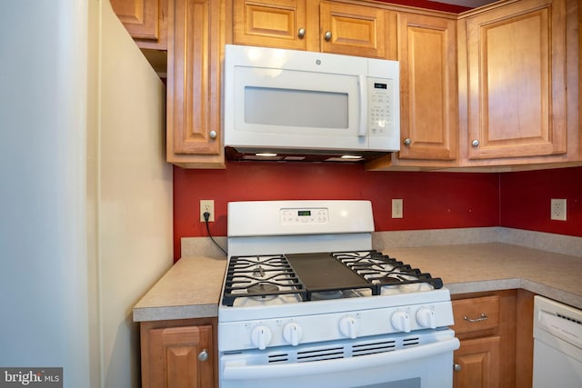 kitchen with light countertops and white appliances