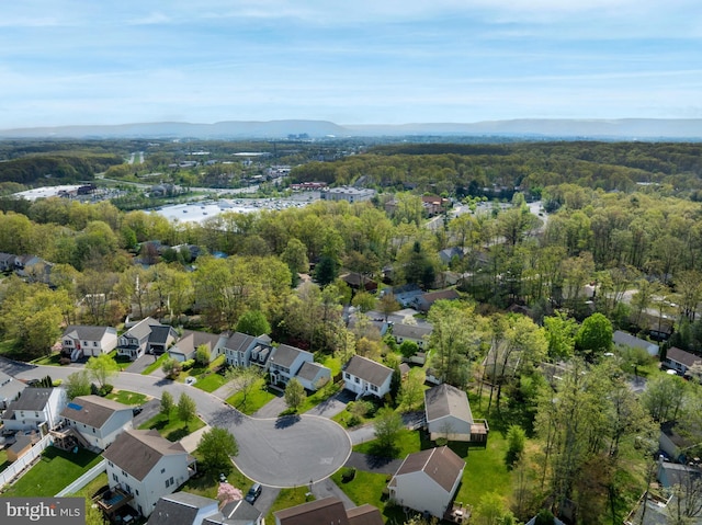 drone / aerial view with a forest view, a mountain view, and a residential view