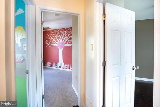 hall with carpet flooring and baseboards