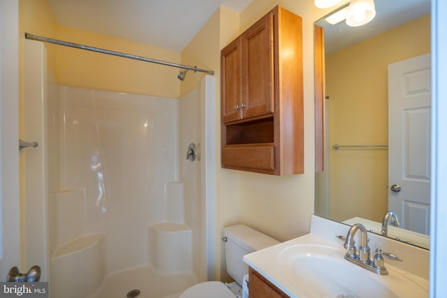 full bathroom with toilet, walk in shower, and vanity