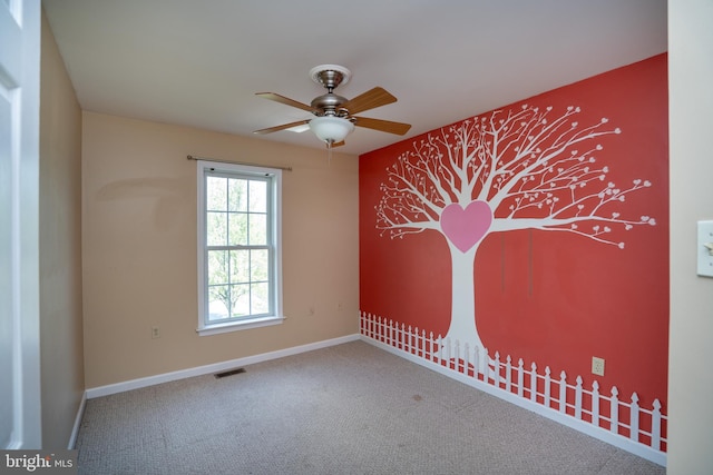 carpeted empty room with ceiling fan, baseboards, and visible vents
