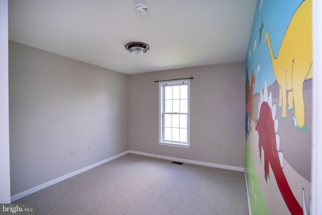 empty room with visible vents, baseboards, and carpet floors