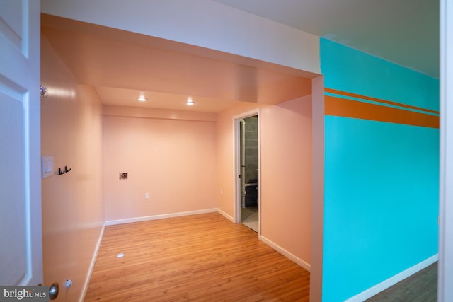 empty room with light wood-type flooring, baseboards, and recessed lighting