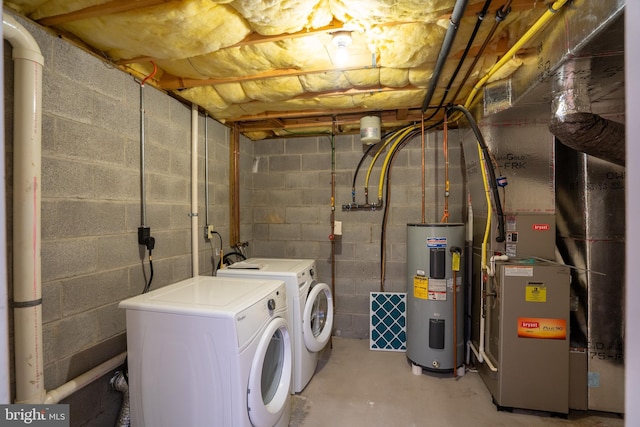 laundry area with washer and dryer, laundry area, and electric water heater