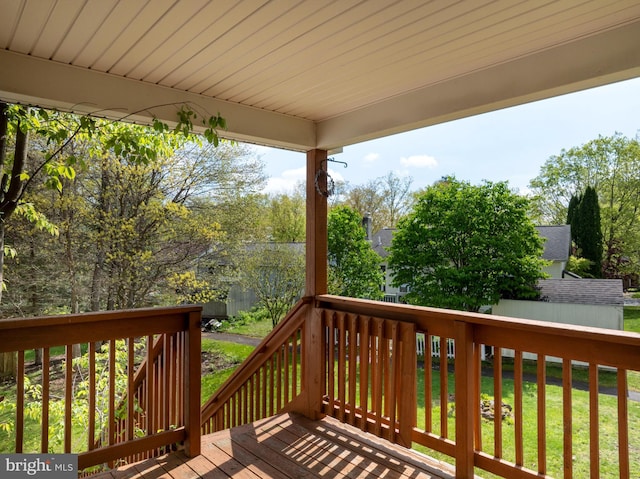 wooden deck featuring a yard