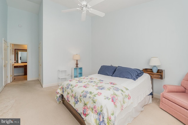bedroom with light colored carpet, baseboards, and a high ceiling