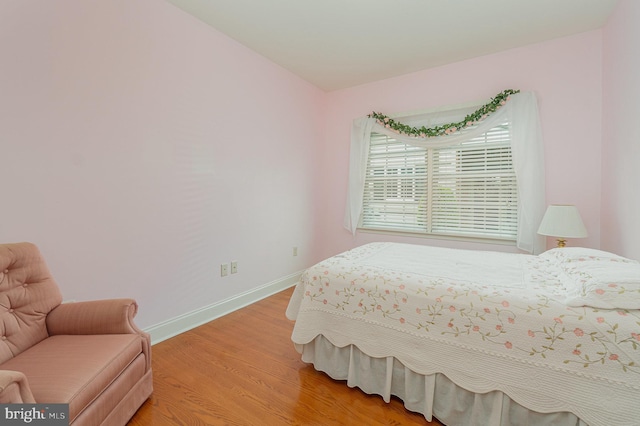 bedroom featuring light wood-style flooring and baseboards