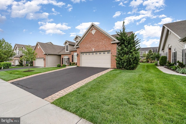 traditional-style house with brick siding, a front lawn, driveway, and a garage