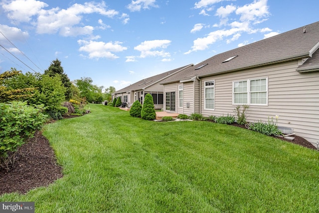 view of green lawn with a patio area