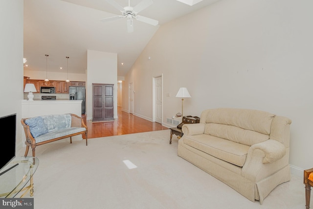 living area featuring high vaulted ceiling, ceiling fan, baseboards, recessed lighting, and light carpet