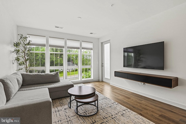 10755 Fairgrounds Dr Unit 320, Fairfax, VA 22030 - living room with plenty of natural light, wood finished floors, and baseboards