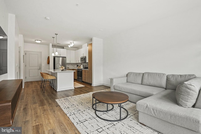 10755 Fairgrounds Dr Unit 320, Fairfax, VA 22030 - living area featuring dark wood finished floors and baseboards