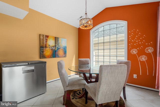 42496 Legacy Park Dr, Brambleton, VA 20148 - dining room with lofted ceiling, light tile patterned flooring, a chandelier, and baseboards