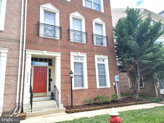 view of front of home featuring entry steps and brick siding