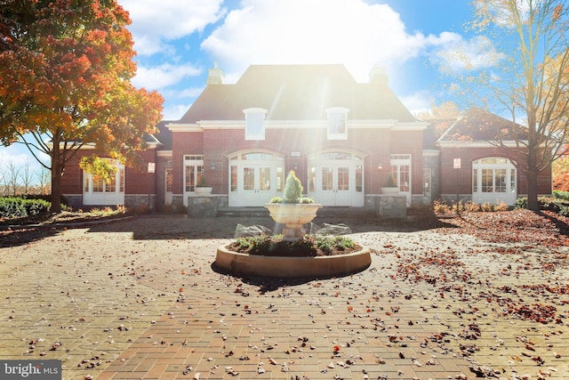 42496 Legacy Park Dr, Brambleton, VA 20148 - rear view of house featuring french doors and a chimney