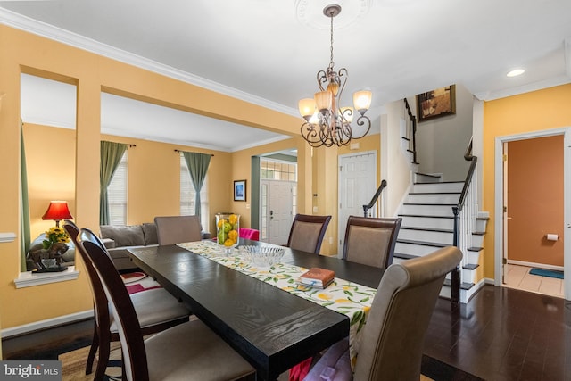 42496 Legacy Park Dr, Brambleton, VA 20148 - dining room with baseboards, a chandelier, wood finished floors, ornamental molding, and stairway