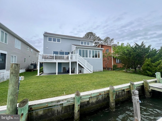10 Riverside Ct, Ocean Pines, MD 21811 - back of property featuring a sunroom, a lawn, central AC unit, stairway, and a deck with water view