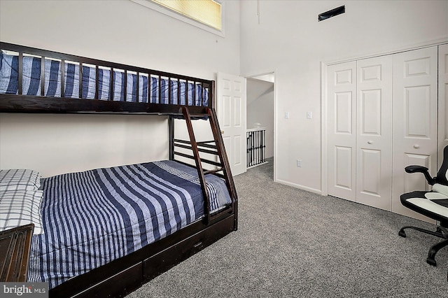 10 Riverside Ct, Ocean Pines, MD 21811 - carpeted bedroom with a closet, baseboards, and a towering ceiling
