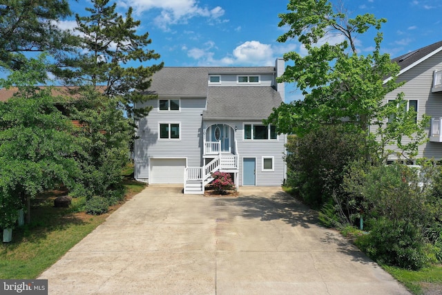 10 Riverside Ct, Ocean Pines, MD 21811 - view of front of house with concrete driveway, a shingled roof, stairs, and a garage