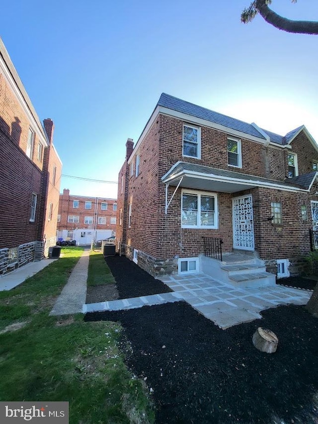 back of house with brick siding
