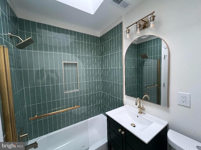 bathroom featuring toilet, visible vents,  shower combination, and vanity