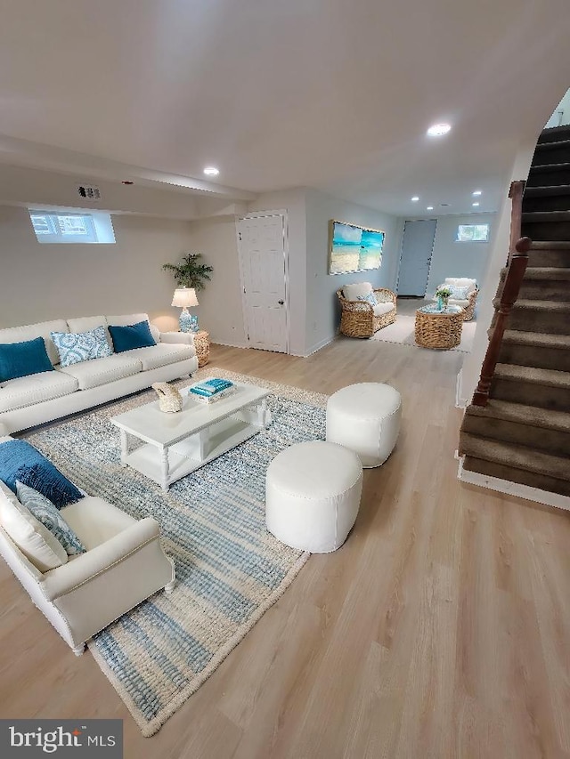 living area featuring stairway, wood finished floors, and recessed lighting
