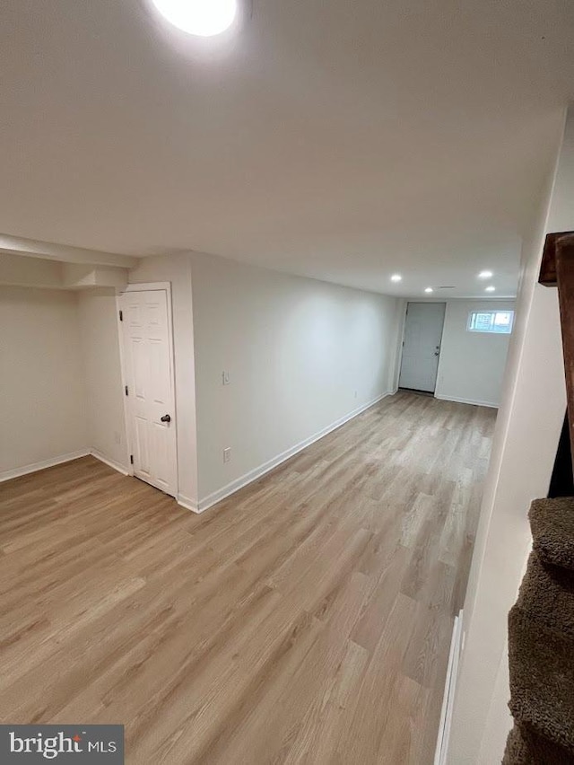 below grade area featuring recessed lighting, baseboards, and light wood-style floors