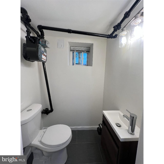 half bathroom with tile patterned flooring, toilet, and vanity