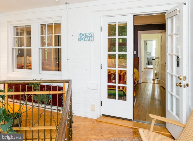 entryway with french doors and wood-type flooring