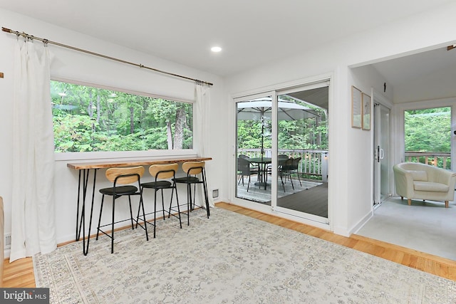 dining space with wood finished floors, recessed lighting, and baseboards