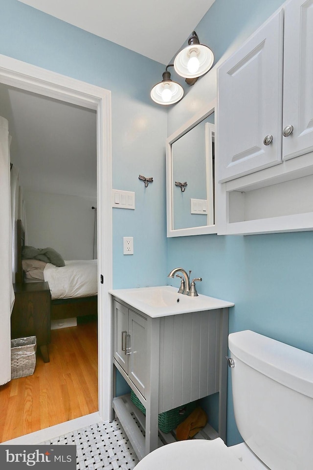 bathroom featuring toilet and vanity