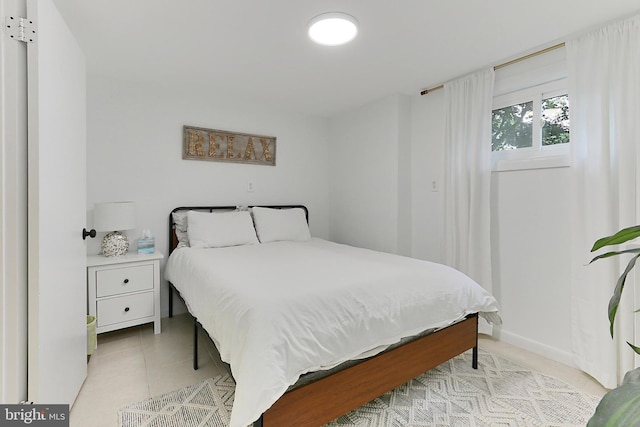 bedroom featuring light tile patterned flooring
