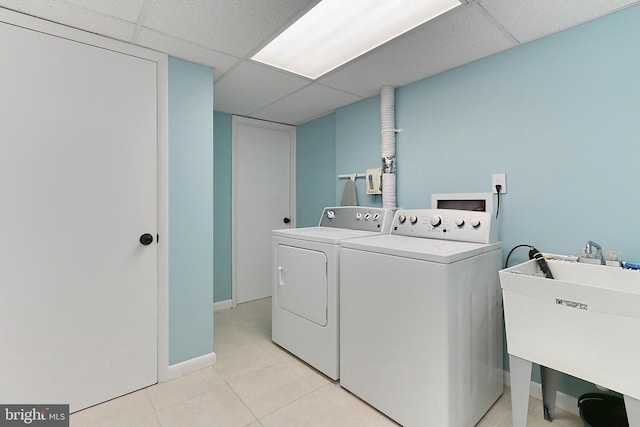 washroom featuring washing machine and dryer and light tile patterned floors