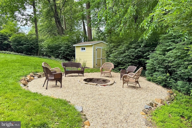 view of green lawn with an outdoor fire pit, a storage shed, an outdoor structure, and a patio area