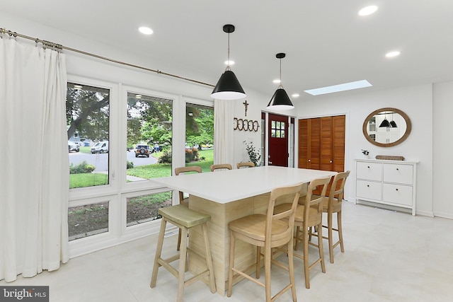 dining area featuring a skylight, recessed lighting, and light floors