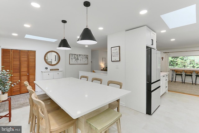 dining space featuring a skylight and recessed lighting