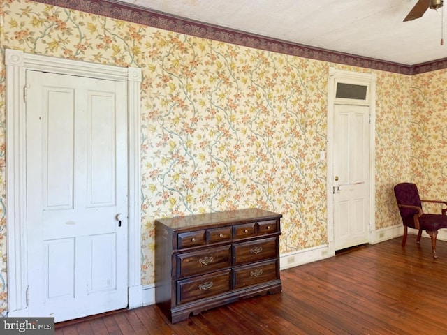 911 E King St, Lancaster, PA 17602 - living area with wallpapered walls, dark wood-type flooring, ceiling fan, and baseboards