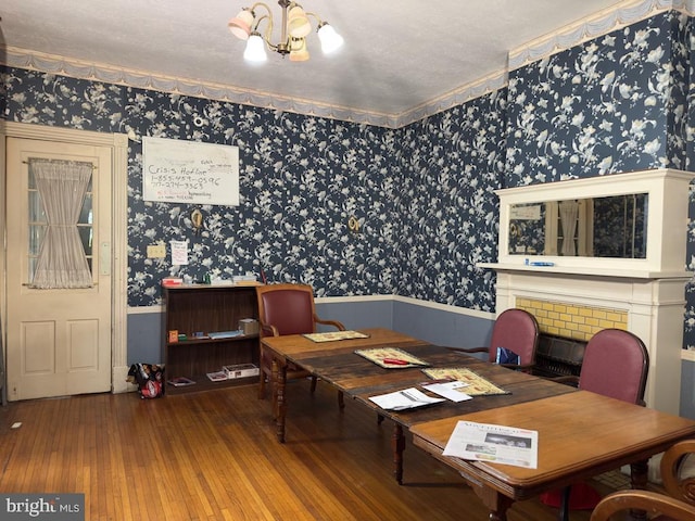 911 E King St, Lancaster, PA 17602 - dining space featuring wainscoting, wallpapered walls, hardwood / wood-style floors, and a chandelier