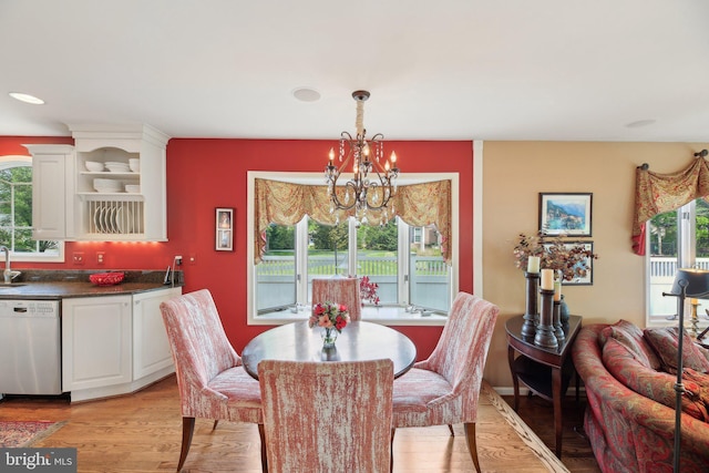 dining space with a chandelier and light wood finished floors