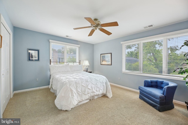 carpeted bedroom featuring baseboards and a ceiling fan