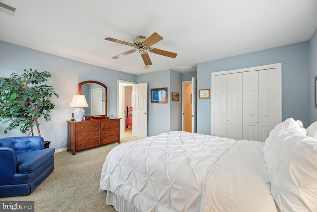 carpeted bedroom with a closet, ceiling fan, and baseboards